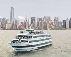 Image of someone happily cruising down a New York City street in a wheelchair