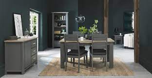 This grey dining table made from thick wood that goes along with dark brown chairs looks amazing in every kitchen. Oakham Dark Grey Scandi Oak Dining Table 6 8 Seater Bentley Designs
