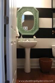 Black And White Accent Wall Bathroom Dwellings By Devore Black And White Striped Bathroom With Images Striped Accent Walls Round Mirror Bathroom Tiny Bathrooms