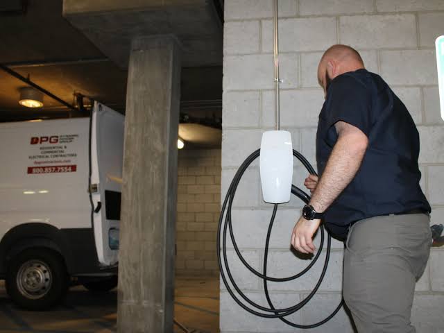 Electrician installing an armoured cable run for a home charge point in GW12