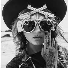 Girl Wearing Sunglasses With Crossing Guns On The Front Sunglasses Cat Eye Sunglasses Eye Sunglasses