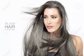 Men come in all shapes and sizes. Beauty Portrait Of An Attractive Young Woman With Long Trendy Silver Grey Hair Blowing Around Her Face In A Breeze Isolated On White In A Hair Care And Glamour Concept Stock Photo