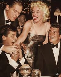 Marilyn with Milton Berle, Jerry Lewis clowning around and Dean Martin.