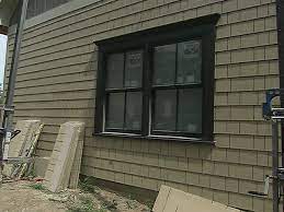Tan Siding Greenish Board And Batten Black Windows Needs Different Trim Exterior House Siding Window Trim Exterior Exterior Siding