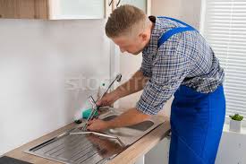 Find out how much a kitchen, bathroom, pedestal or undermount sink costs. Plumber Fixing Faucet In Kitchen Sink Stock Photo C Andreypopov 6050043 Stockfresh