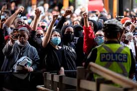 Simultaneous online and offline protests involving physical representations of protesters in public spaces that are subsequently assembled online. Protesters Rally Against Anti Black Indigenous Racism In Toronto Victoria News