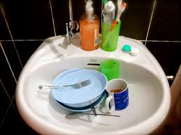 washing dishes in the bathroom sink