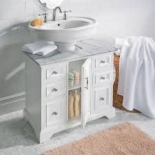 A Pedestal Sink Cabinet With Marble Top And Brushed Nickel Hardware Gives It A Traditiona Pedestal Sink Storage Small Bathroom Storage Bathroom Storage Cabinet