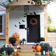 What A Festive Fall Farmhouse Front Porch By Danielle Gutelli The Painted White Brick Black Front Door And N Halloween Front Doors Fall Decor Halloween Porch