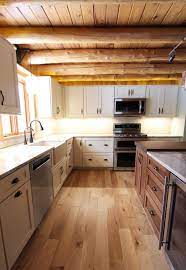 You'll want to focus on rough paint for a worn look or faded paint for a soft finish. Log Cabin Rustic White Kitchen Cabinets With Granite And Wood Countertops Rustic Kitchen Cleveland By Cabinet S Top Houzz