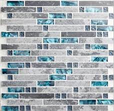 While most people pair their gray kitchen cabinets with similar neutral hues such as black and white or bold primary colors such as red and blue, there are other more complicated ways to style your gray cabinets. Gray Marble Backsplash Tile Peacock Blue Glass Mosaic Random Wave Patterns Aqua Crystal Interlocking Mosaic Backsplash Kitchen Mosaic Tile Kitchen Teal Kitchen