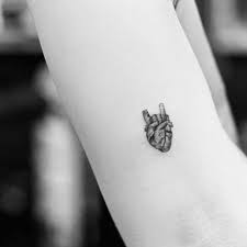 Fine Line Rock Salute Anatomical Heart Tattoo On The Inner Arm Anatomical Heart Tattoo Heart Tattoo Rock Tattoo