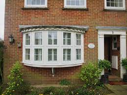 While blinds rattle or curtains sway with one or more windows opened, shutters remain in place. Bay Window Shutters Fitted In Lymington Outside View Shuttersouth Shuttersouth