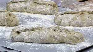 Sebuah buku terbuka terletak di atas perisai ini. Finland Rolls Out Bread Made From Crushed Crickets Bbc News