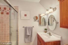 A master bathroom in need of an update was modernized with a barn door, new vanity and modern natural tile selections. Color Scheme Ideas For Bathroom With Maple Cabinets
