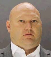 Dallas officer turns himself in after being charged in death