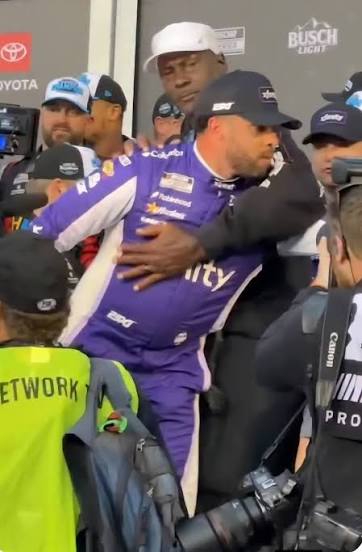 Michael Jordan hold Bubba Wallace during the FOX Hot Pass broadcast of the  2026 Daytona 500, whispering encouragement after 23XI Racing's first win  via teammate Tyler Reddick, while Wallace finished a disappointing