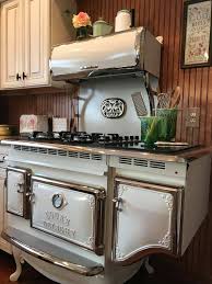 Iron wood burning stove with firewood and fire set. Modern With An Antique Twist Elmira Stove Works Fireplaces Plus Inc