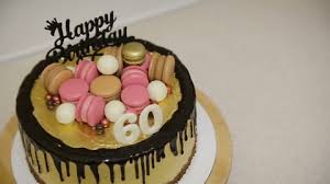 This purple and blue tier flower cake is perfect for a 60 year old special woman! Decorating Cake With Macaron Cookies Stock Footage Video 100 Royalty Free 1027502441 Shutterstock