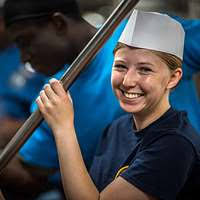 Culinary Specialist Seaman Richard Burns rinses a boiler