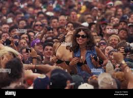 A concert goer is shown flashing in the crowd at Woodstock 94 in  Saugerties, New York Stock Photo - Alamy