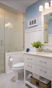 In true coastal window style, this round mirror looks beautiful in this modern coastal bathroom with muted blue wainscoting and a large white bathtub for soaking. Beach Bathroom Ideas Photos Bathroom Ideas