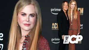 Nicole Kidman holds hands with Keith Urban at the CMA Awards