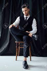 Sitting male poses are always popular. Confident Handsome Man In Elegant Suit Posing Sitting In Chair Stock Photo Picture And Royalty Free Image Image 123840367