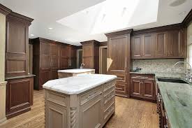 The piece is usually of the same style as your cabinets but it looks absolutely different, and it can make a statement with its color or decor. 43 Kitchens With Extensive Dark Wood Throughout Home Stratosphere