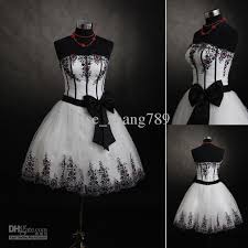 This bride chose a chic black and white wedding dress with an elegantly patterned cathedral veil. Short Black And White Wedding Dress Black Wedding Dresses White Dresses Online New Wedding Dresses