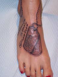 A simple name displayed with a cross or heart shows that the person. Dog Tag Tattoo Designs