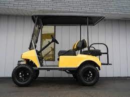 this custom 2003 club car ds gas golf car is street ready and decked out with a new yellow body 6 inch lift kit 2 tone custom golf carts golf car golf carts