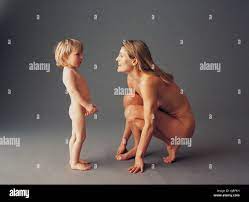 Nude image of mother and infant son playing Stock Photo - Alamy