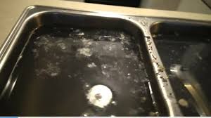 backed up sink spews garbage water into