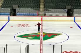 A late, cold night with the painstaking task of painting the Wild's ice