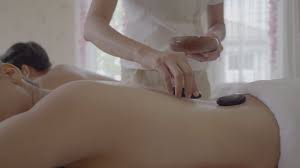 Young woman having hot stone massage in spa 1802487 Stock Video at Vecteezy