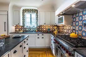 It will never go out of style. Contemporary Kitchen With White Cabinets And Spanish Mosaic Tile Backsplash Hgtv