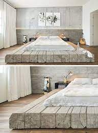 this bed sitting on platform made of reclaimed logs adds a rustic yet contemporary feel to the large bedroom bedroom design house design minimalism interior