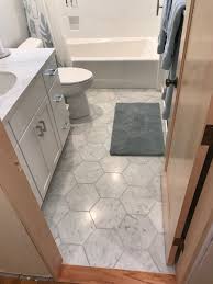A tall central storage tower in the middle allows for extra storage and allowing the countertops to be free of clutter. Light Grey Bathroom Devoe Construction Design