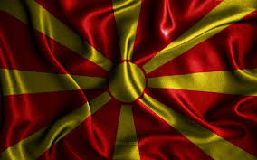A stylised yellow sun is featured in the center of the field. Download Wallpapers Macedonian Flag 4k Silk Wavy Flags European Countries National Symbols Flag Of North Macedonia Fabric Flags North Macedonia Flag 3d Art North Macedonia Europe North Macedonia 3d Flag For Desktop