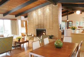 A natural brick fireplace surrounded by a classic white mantel draws attention to the simple fireplace in a colorful room. Jimbrown 20 Knight And Piercy 2 1 Web Home