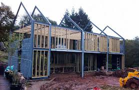 Erecting The Steel Frame Steel Frame House Steel Building Homes Metal Building Homes