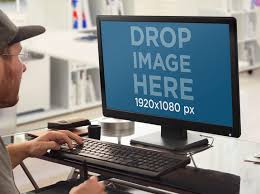 Placeit Pc Mockup Template Of Young Designer Working On Desktop Pc At The Office Mockup Generator Templates Mockup