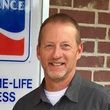 Men from the police department help elderly couple with tire