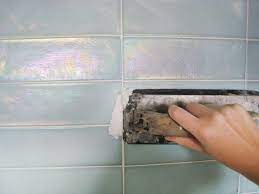 Comb the mortar with a trowel until it is uniform in thickness, then smooth out the grooves in the mortar with the edge of the. Kitchen Update Add A Glass Tile Backsplash Hgtv