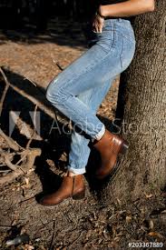 Black chelsea boots with 40mm stacked heel. Brown Shiny Leather Womens Chelsea Boots On Woman Legs With Blue Jeans In Autumn Forest Or Park Buy This Stock Photo And Explore Similar Images At Adobe Stock Adobe Stock