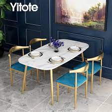 A small pedestal dining table would be perfect in a kitchen corner for breakfast or quick meals, and a round pedestal dining table fits well for entertaining without having to choose who sits at the head of the table. Yitote Nordic Marble Dining Table And Chair Combination Simple Modern Small Apartment Household Rectangular Dining Table Gold Dining Tables Aliexpress