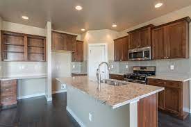 See more ideas about kitchen design, medium wood kitchen cabinets, wood kitchen cabinets. Warm Rich Medium Brown Cabinets Paired With Small Details Of Grey And Modern Subway Tile Make T Brown Kitchen Cabinets Brown Kitchens Kitchen Countertop Trends