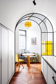 A stylish black and white house with an entire wall made of glasses and black metal framework to divide kitchen to the living room. Decorative Glass Panels And Interior Windows Glass Design Ideas