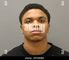 This undated photo provided by the Chicago Police Department shows Eric  Adams. Adams and Michael Washington have been charged with with  first-degree murder in the Chicago shooting death of a woman who